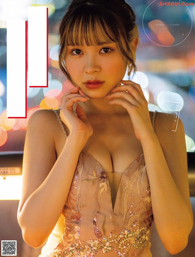 A woman in a pink dress posing for a magazine cover.