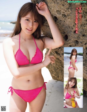 A woman in a bikini posing on the beach.
