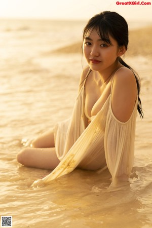 A woman in a bikini standing on a beach.