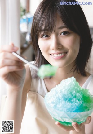 A woman in a pink shirt smiles at the camera.