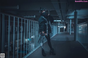 A woman in a black jacket and thigh high boots.