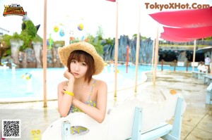 A woman in a black and white bikini standing in a pool.