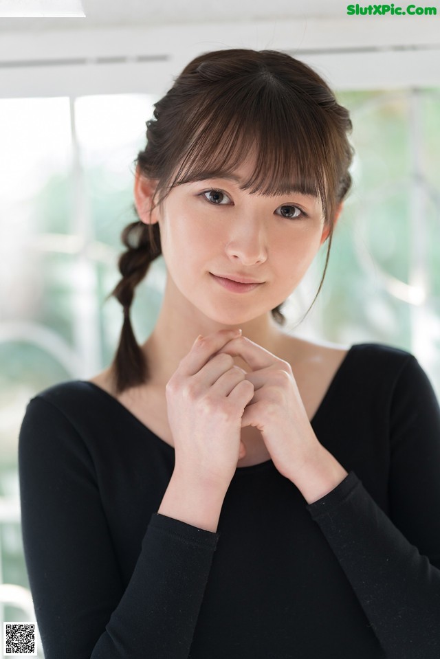 A woman in a black shirt is posing for a picture.