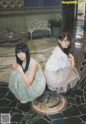 A couple of young women holding hands in a magazine.
