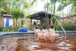 A group of naked women walking down a sidewalk.