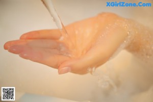 A woman is taking a bath in a bathtub filled with foam.