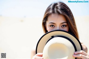 A woman with long brown hair is posing for the camera.