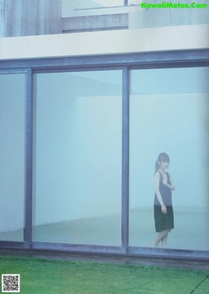 A magazine with a picture of a woman in a black dress.
